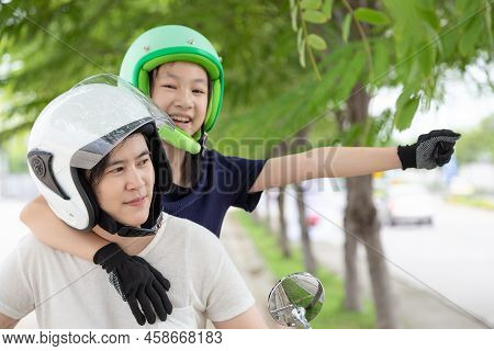 Mother And Daughter Traveling On Motorcycle,motorcyclist Wearing Safe Helmet Before Travel On Motorc