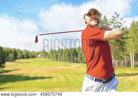 Golfer Hitting Golf Shot With Club On Course While On Summer Vacation.