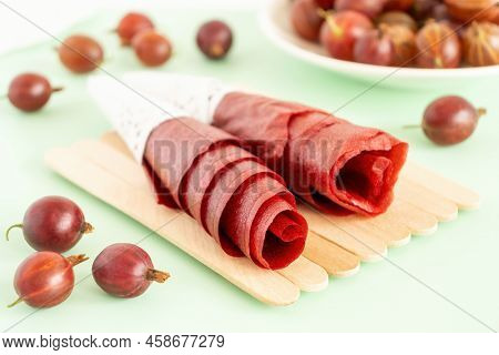 Red Gooseberry Pastila Closeup. Homemade Fruit Leather Rolls. Dehydrated Mashed Berries Rollups.