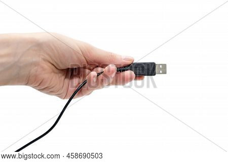 Black Usb Cable In Hand On On A White Background. Modern Technologies In Everyday Life. Human Hand H