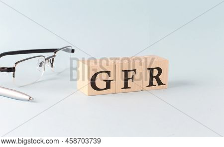 Wooden Cubes With The Word Gfr - Glomerular Filtration Rate On A Financial Background With Chart, Ca