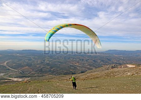 Paraglider In The Mountains Above Loja, Spain