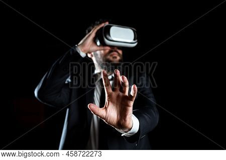 Male Professional Wearing Virtual Reality Goggles Gesturing And Introducing Modern Technology Of Lea