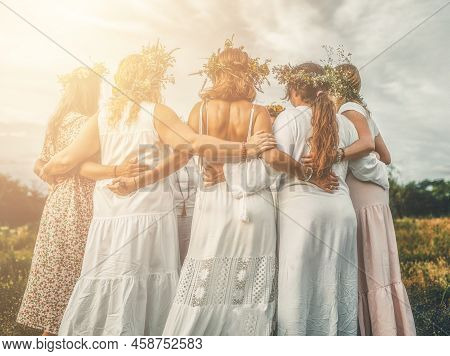 Women In Flower Wreath On Sunny Meadow, Floral Crown, Symbol Of Summer Solstice.