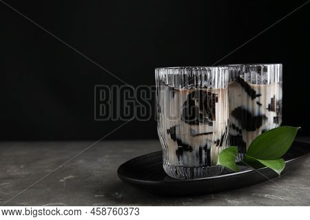 Glasses Of Milk With Grass Jelly And Green Leaves On Grey Table, Space For Text
