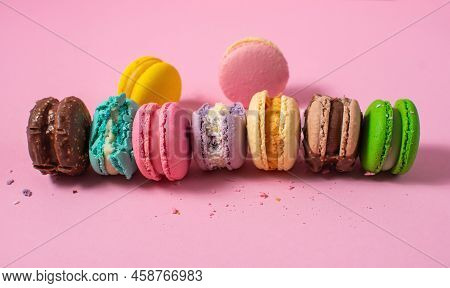 Bright Colorful Various Flavor Macarons Sweet Cookies On Pink Background