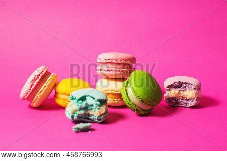Bright Colorful Various Flavor Macarons Sweet Cookies On High-colored Pink Background