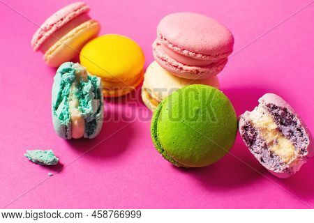 Bright Colorful Various Flavor Macarons Sweet Cookies On High-colored Pink Background