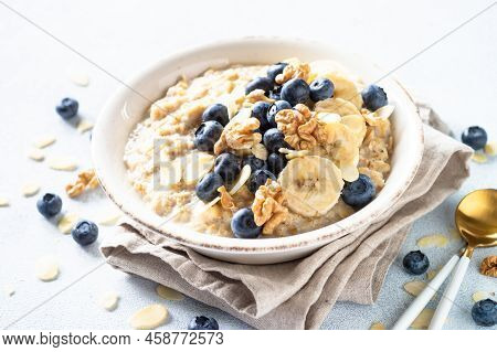 Oatmeal Porrige In Craft Bowl At White Background. Healthy Breakfast.