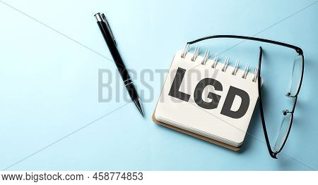 Lgd - Loss Given Default Text Written On Notepad On The Blue Background