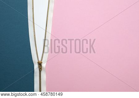 Top View On Teal And Pink Colored Textured Papers Connected With Half Opened White Zipper. Closeup W