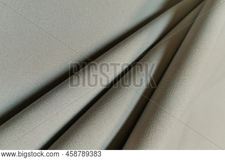 Beige Crumpled Or Wavy Fabric Texture Background. Abstract Linen Cloth Soft Waves. Gabardine Wool Fa