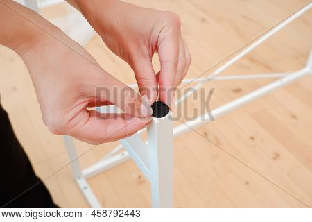 Woman Are Sticking Floor Care Pad At Table Legs. Woman Attach Felt Pad On Chair Leg, Care Of Floor. 