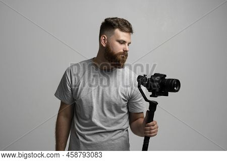 Videographer Making A Good Footage Using Steadicam. Cameraman Creator With A Stabilizer In His Hands