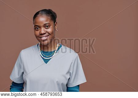 Portrait Of African Young Social Worker In Uniform Smiling At Camera Isolated On Beige Background