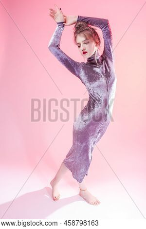 Full Length Portrait Of Winsome Sexy Caucasian Girl In Shiny Gray Dress Posing Standing With Lifted