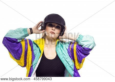 Closeup Portrait Of Young Caucasian Female  Sportwoman In Fitness Outfit And Baseball Cap With Wirel