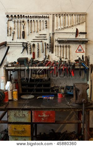 Muchas herramientas sucias en mesa y tablero de instrumentos