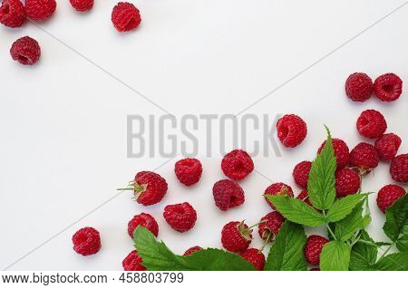 Ripe Juicy Fresh Raspberries With Green Leaf On White Background Flat Lay Top View. Raspberry Patter
