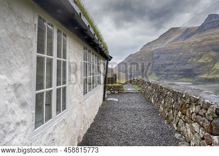 Beautiful Little Church, With A Grassy Roof, Against The Backdrop Of Beautiful Mountains, And Dramat