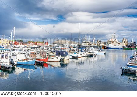 Faroe Islands. Denmark. 11 May. 2022. Boats Parked In The Bay, Among The Beautiful Small, Colorful H