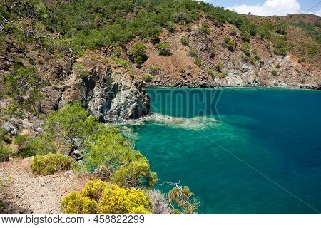 Picturesque Seascape. View Of Bay Of Mediterranean Sea With Turquoise Water And Rocky Red Mountains 