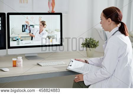 General Pratitioner Having Video Call With Pulmonologist, They Are Discussing Chest X-ray Of Patient
