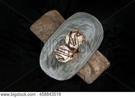 Two Cinnabon Chocobon (soft Chocolate Buns) Topped With Rich Cream Cheese Frosting On Ceramic Tray W