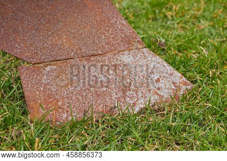 Close-up Of An Old Rusty Plow On The Grass, A Plow For Plowing