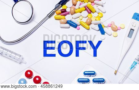 On A White Background Pills, Stethoscope, Syringe, Thermometer And Text Eofy. Medical Concept