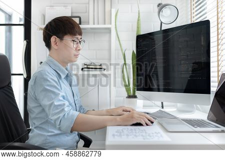 Professional development programmers are sit on a desk with work equipment such as: computer-laptop-