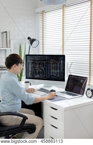 Professional development programmers are laying out a structure or draft on paper in preparation for