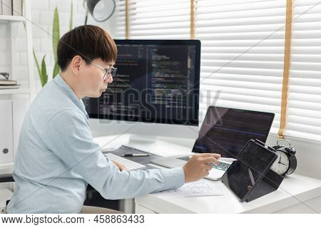 Professional Development Programmers Are Using Tablet To Test The Functionality Of Their Application