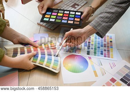 Team Of Creative Designer Brainstorming, Discussing Ideas For Design Project Together