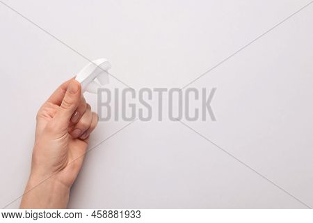 Woman Holding Anti-snoring Device On Light Grey Background, Top View. Space For Text