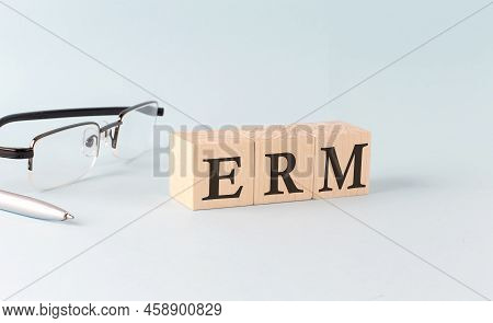 Text Erm Written On Wooden Cubes On Blue Background