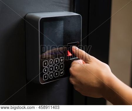 A Woman Opens The Door With Her Fingerprint. Modern Keyless Entry Lock.