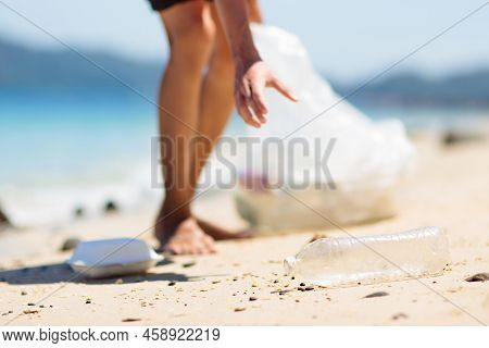 Plastic Garbage. Sea And Ocean Pollution. Beach Clean Up. Young Man Picking Used Plastic Bottles On 