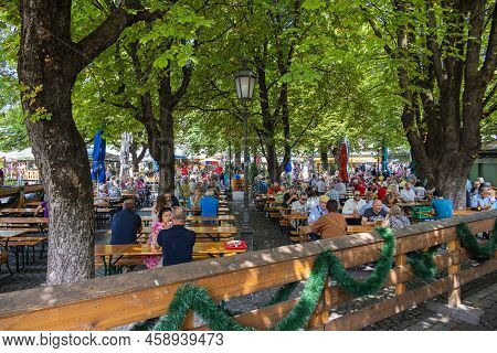 Munich, Germany - July 6, 2022: Beer Garden On The Viktualienmarkt At Lunch Time. Locals And Tourist