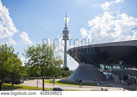 Munich, Germany - July 6, 2022: View Past The Glass Facade Of Bmw World To The München Olympia Park 