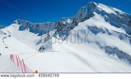 Big Mountain Covered With Snow At Zeo Point Place With Red Border Line To Divide Two Countries.