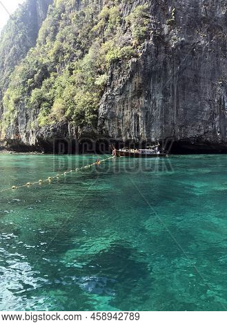 Landscape In Thailand. The Photo Shows Sea Water, Rocks In The Water And Mountains.
