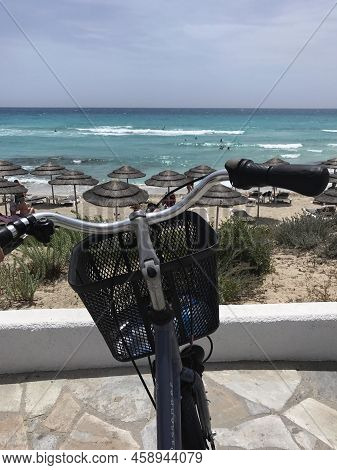 Cyprus, Ayia Napa. Sea View, Beach. In The Foreground Is A Bicycle.