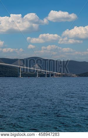 Beautiful Bridge Across The Sea To Peljesac Peninsula In Croatia. There Are Dramatic Clouds In The S