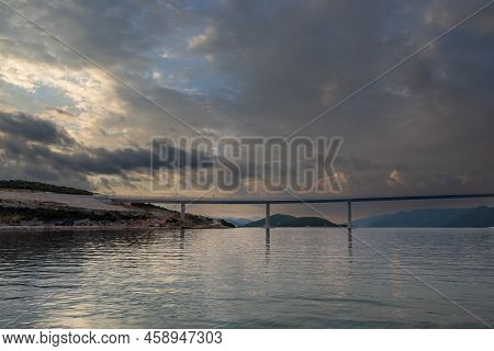 Beautiful Bridge Across The Sea To Peljesac Peninsula In Croatia. There Are Dramatic Clouds In The S