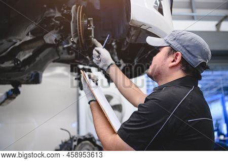 Asian Male Car Technician Car Maintenance For Customers According To Specified Vehicle Maintenance C