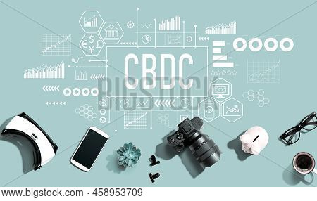 Cbdc - Central Bank Digital Currency Concept With Electronic Gadgets And Office Supplies - Flat Lay