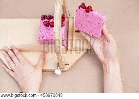 A Soap Maker Cuts Multi-colored Pieces Of Soap On A Special Wooden Device. View From Above. Only Han