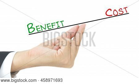 A Man Hand Bhem Looks Of Comparison Between Benefit And Cost The Concept Of Business Sale And Produc