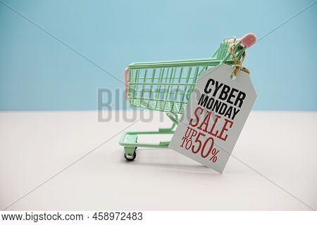 Cyber Monday Sale 50%  Text Message On Price Tax With Shoppint Trolley Cart On Blue Andp Pink Backgr